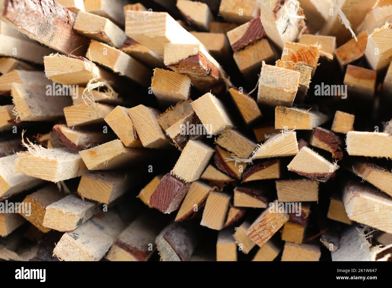 Defocus piles of wooden boards in the sawmill, planking. Warehouse for sawing boards on a sawmill outdoors. Wood timber stack of wooden blanks constru Stock Photo