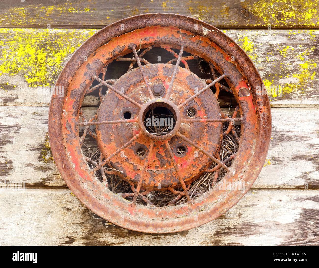 Vintage Metal Wheel hanging for decor outside a barn in Northern California Stock Photo