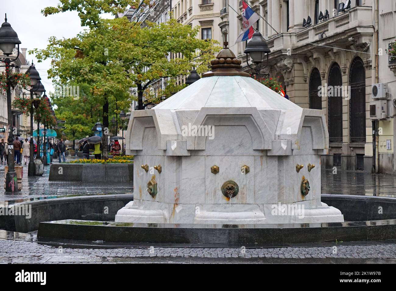Belgrade, Serbia - October 10, 2015: White marble Delija drinking water fountain at Knez Mihailova pedestrian street by architect Aleksandar Deroko ra Stock Photo