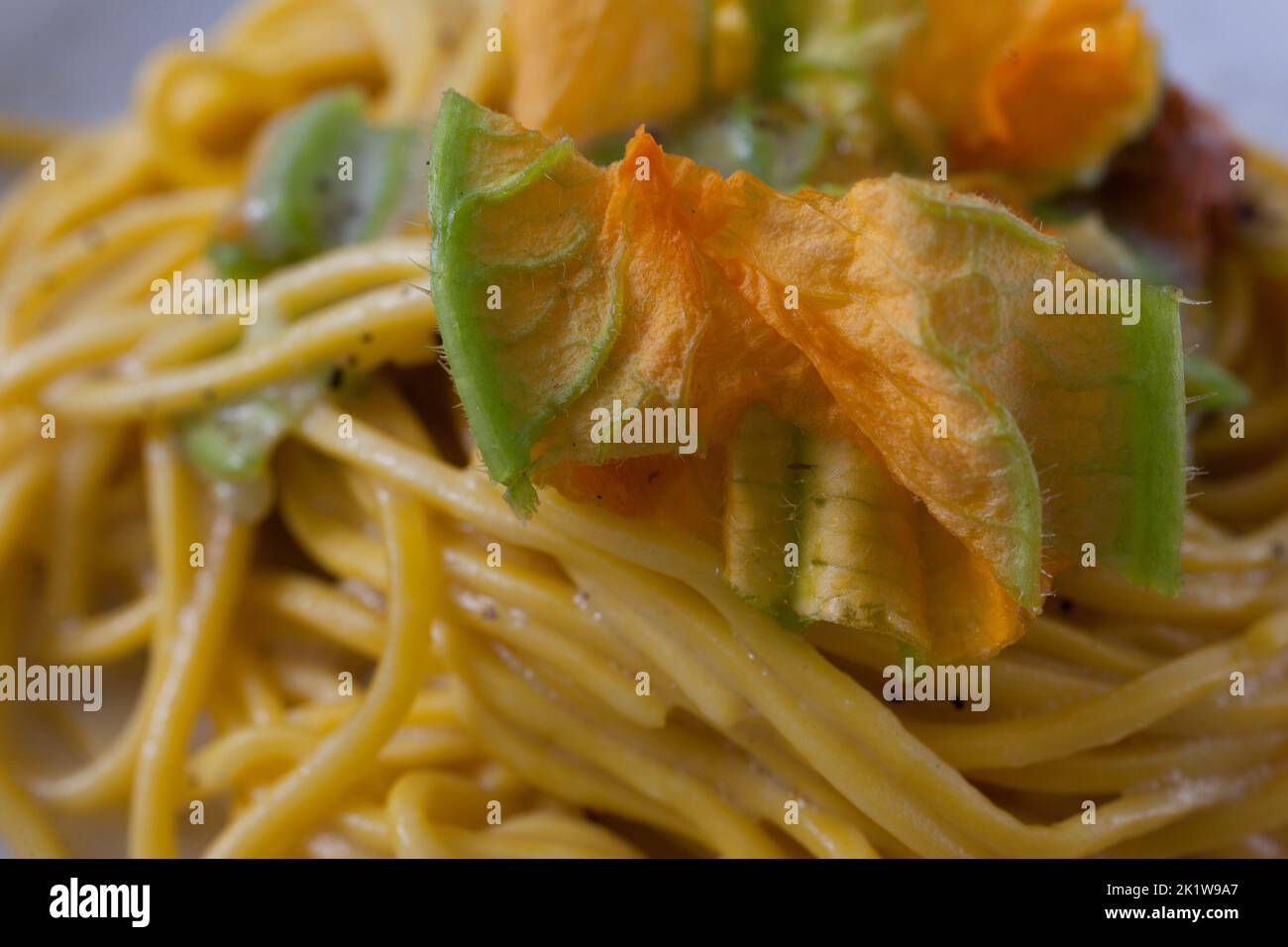 Creamy spaghetti with zucchini flower Stock Photo Alamy