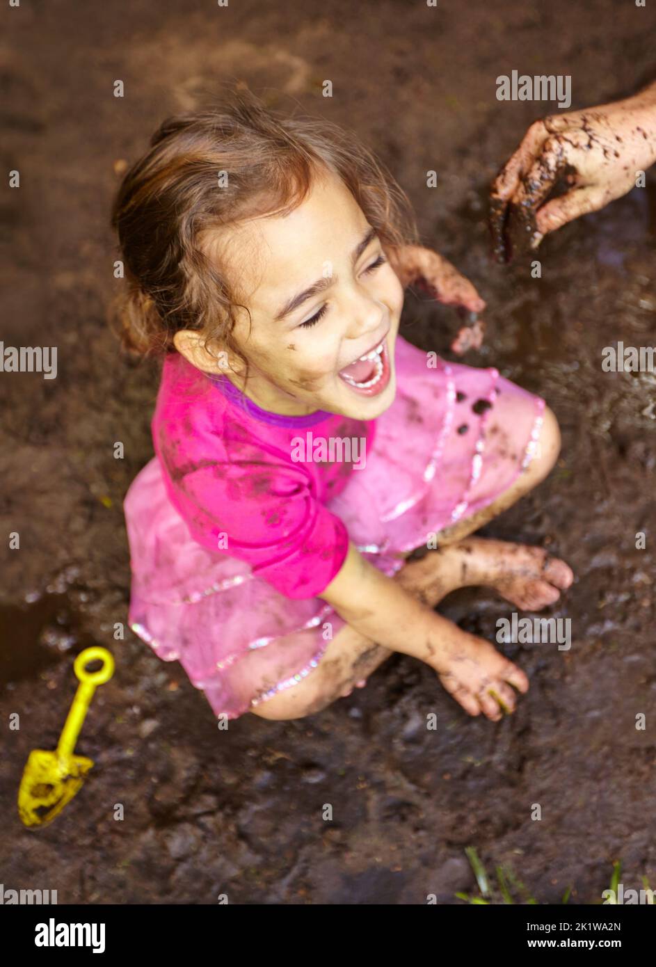Theres nothing more fun than mud. a little girl laughing while playing