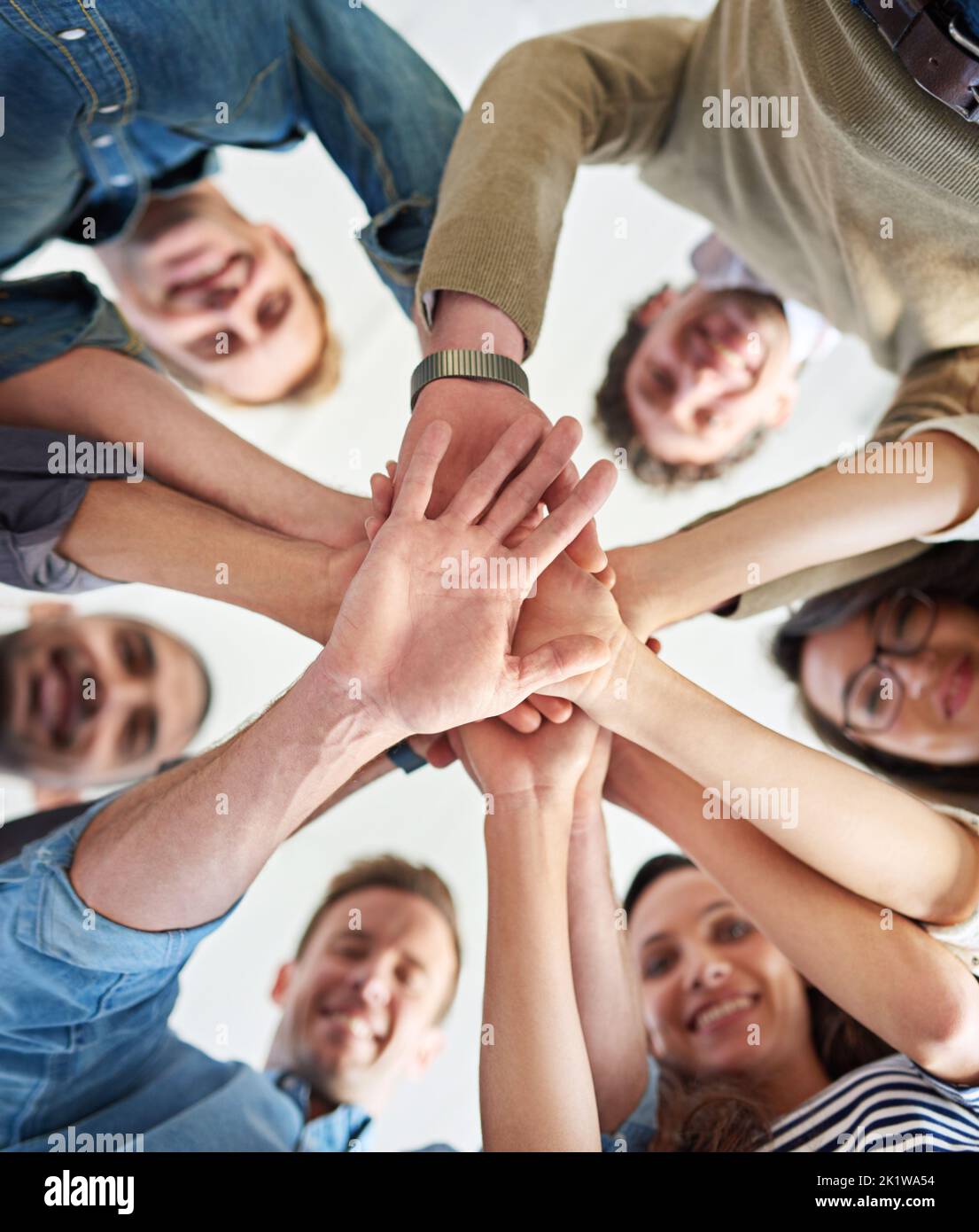 Together we can complete any task. Low angle shot of a group of co ...