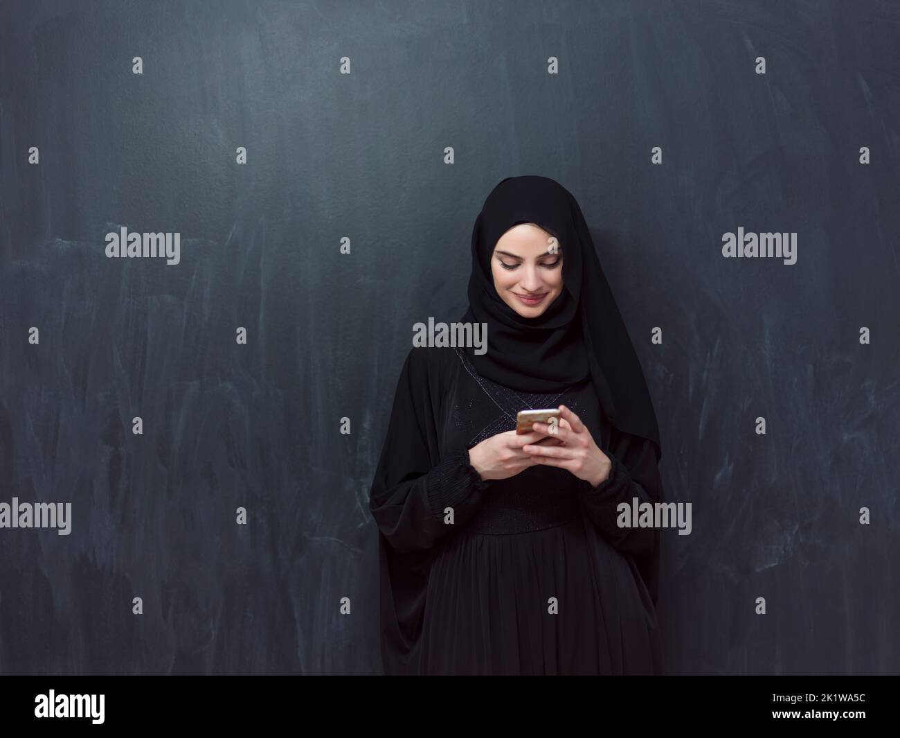 Young modern muslim business woman using smartphone wearing hijab ...