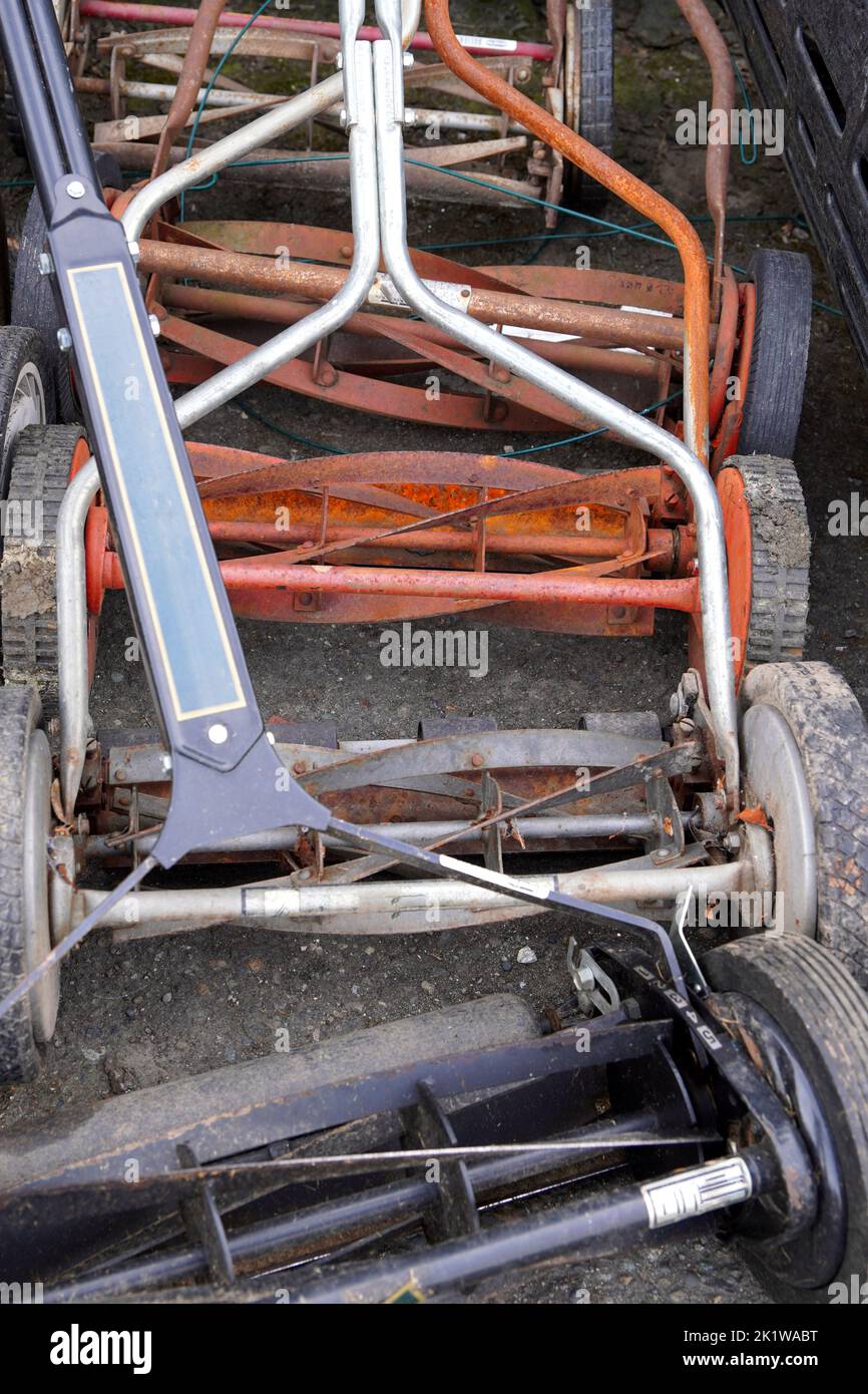 Collection of old used push lawn mowers Stock Photo