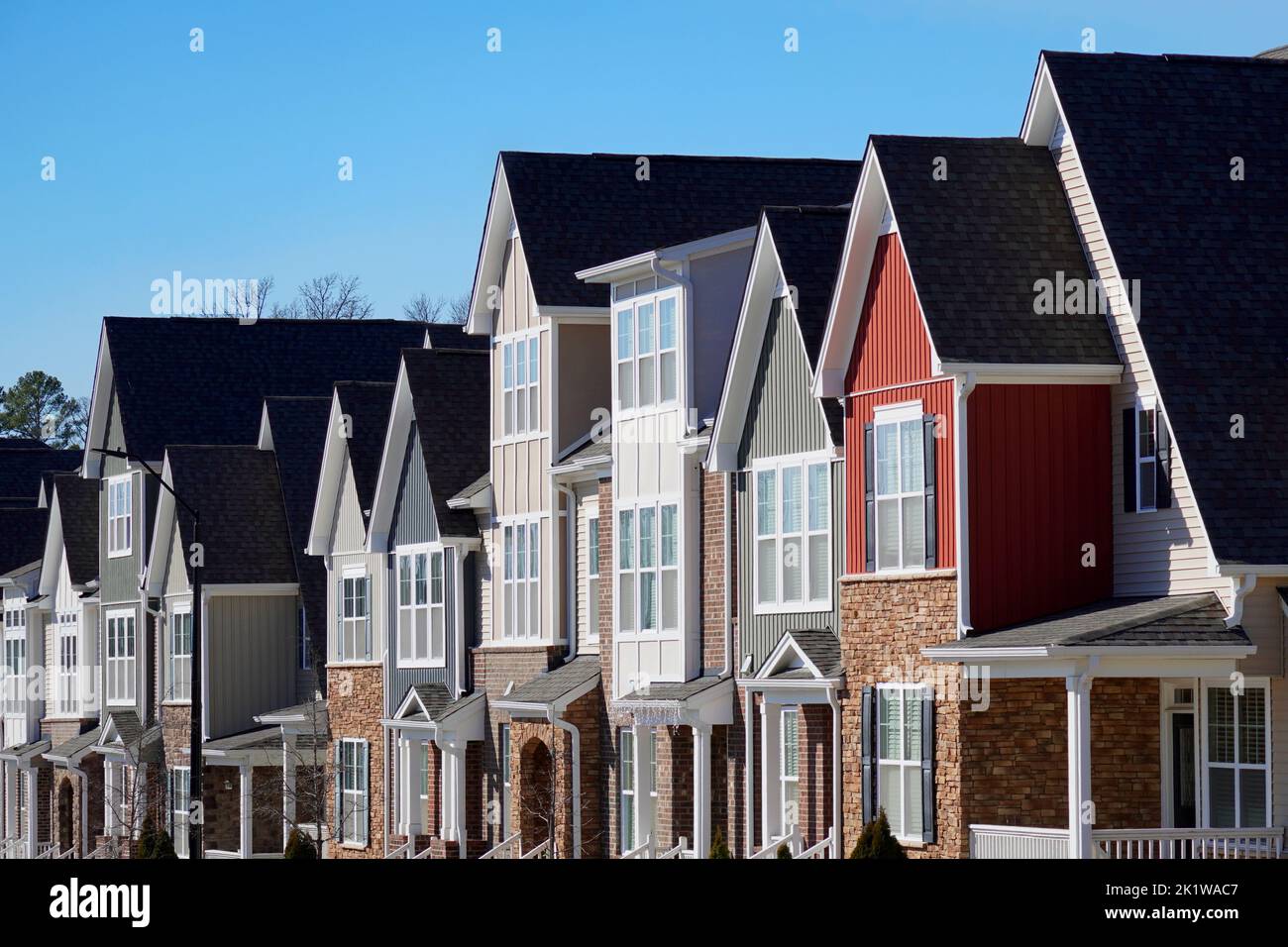Row of modern townhouses under a blue sky Stock Photo