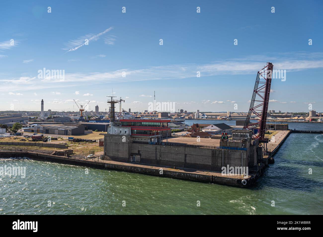 Europe, France, Dunkerque - July 9, 2022: WWII German submarine base concrete bunkers under bridge of lock to harbor installations under blue sky. Cit Stock Photo