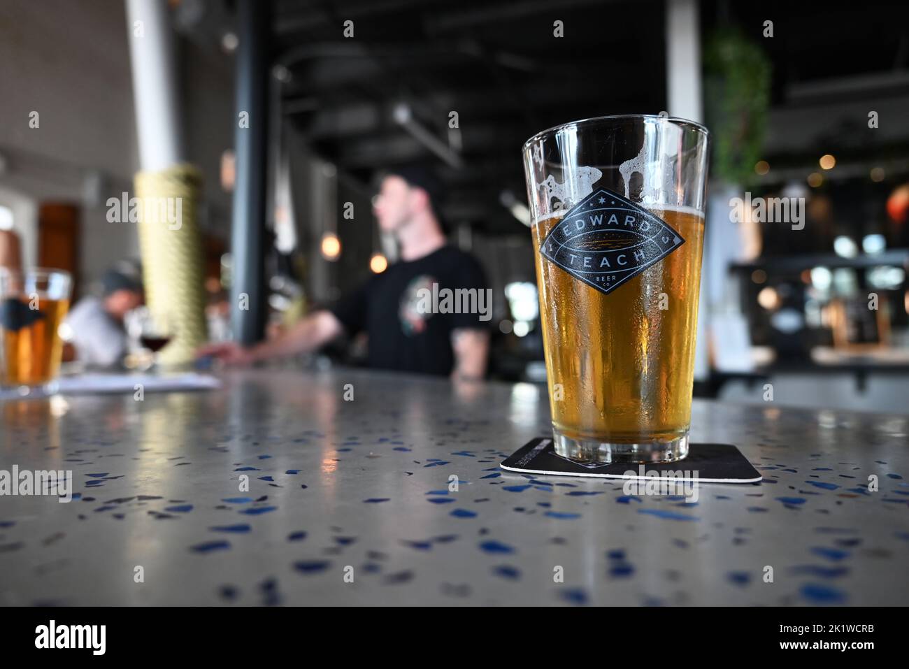 Wilmington, NC, August 6, 2022 - Close up of pint glass with beer on the main bar of Edward Teach Brewery. Stock Photo