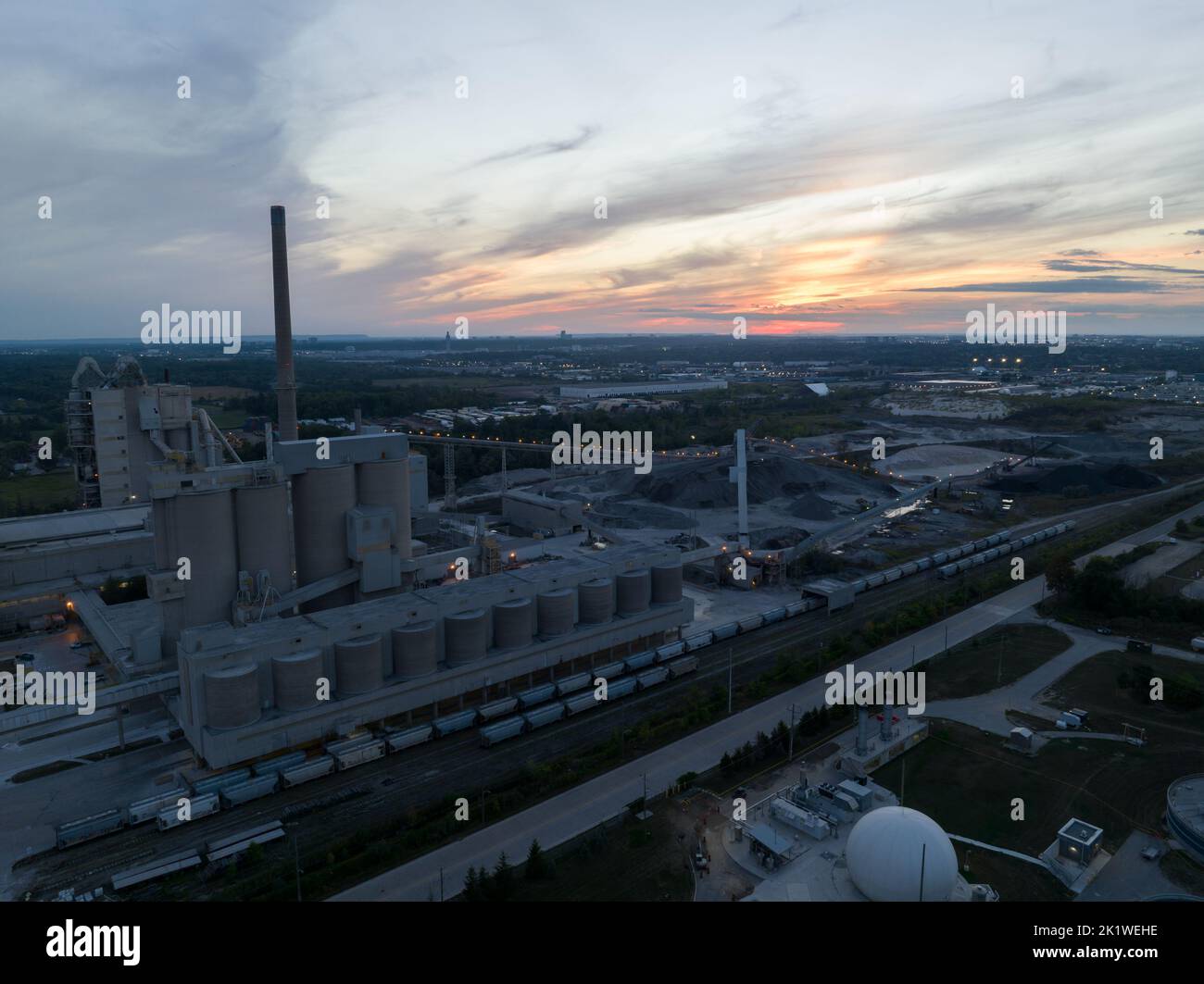 An aerial view looking at a large coal facility at dusk, a beautiful sky in the background. Stock Photo