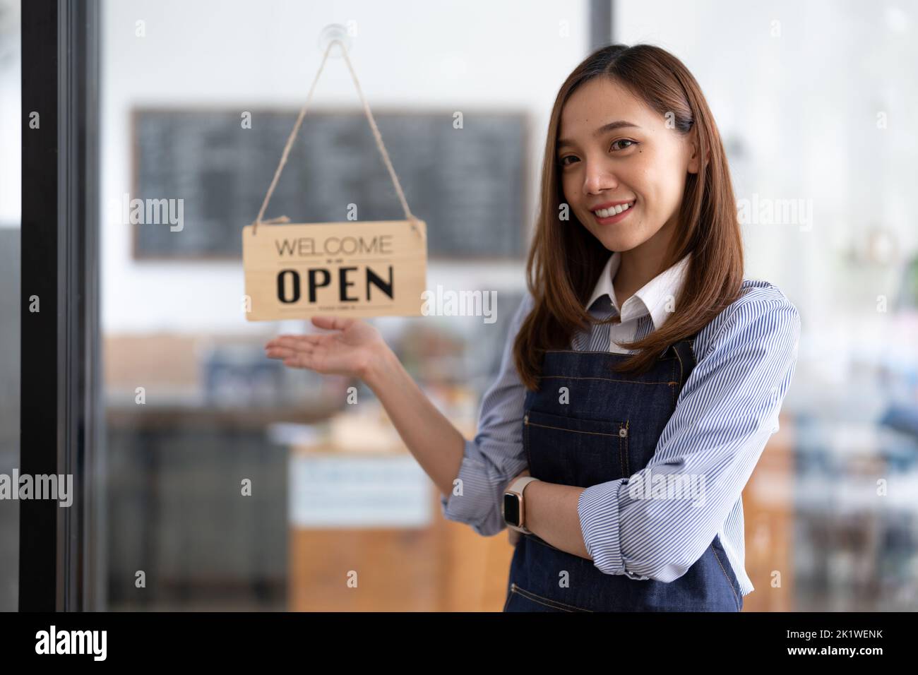 Welcome open shop barista waitress open sign on glass door modern coffee shop ready to serve restaurant cafe retail small business owners. Stock Photo
