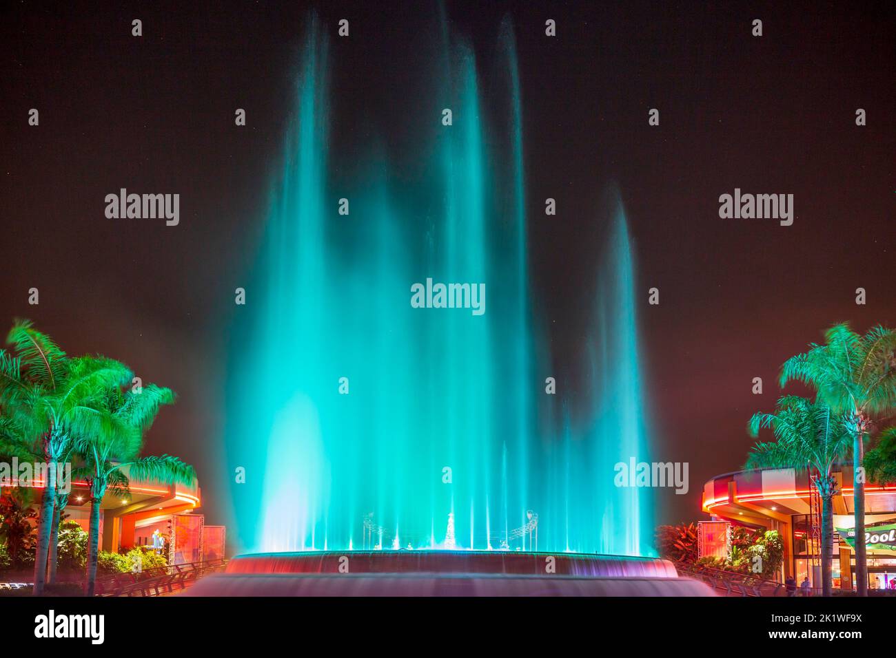 A colored water fountain illuminated at night at Epcot Center, Orlando
