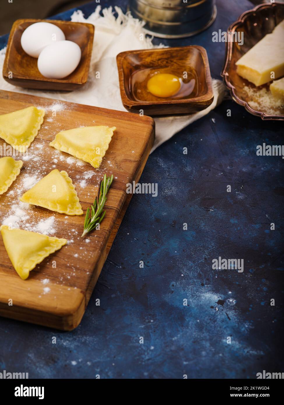 Cooking homemade Italian ravioli. Raw ravioli on a wooden cutting board ...