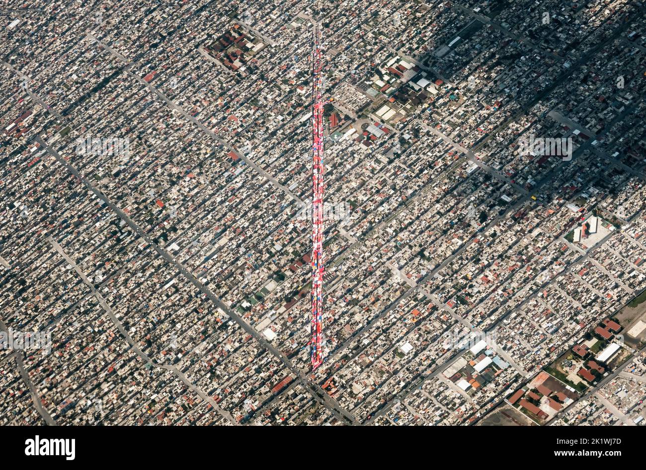 A Mexico City seen from the heights with urban areas and airplane