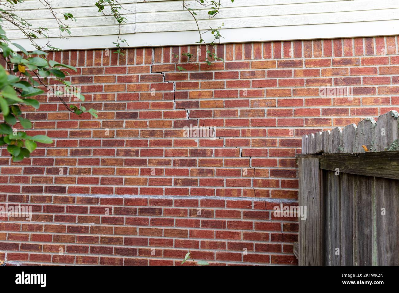 Crack in bricks of home from foundation problems Stock Photo