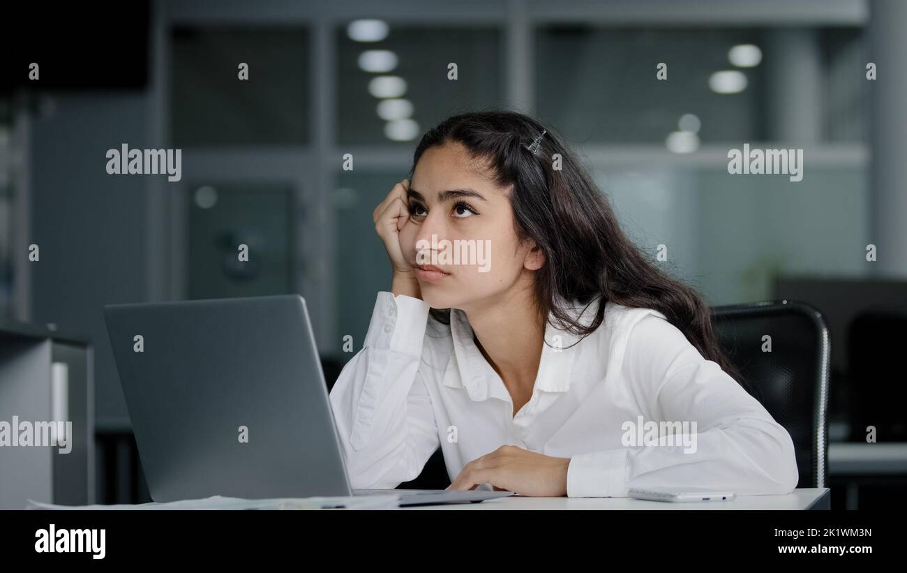 Sad bored lazy young woman typing on laptop tired unmotivated businesswoman office worker feels fatigue from working at computer suffers from overwork Stock Photo