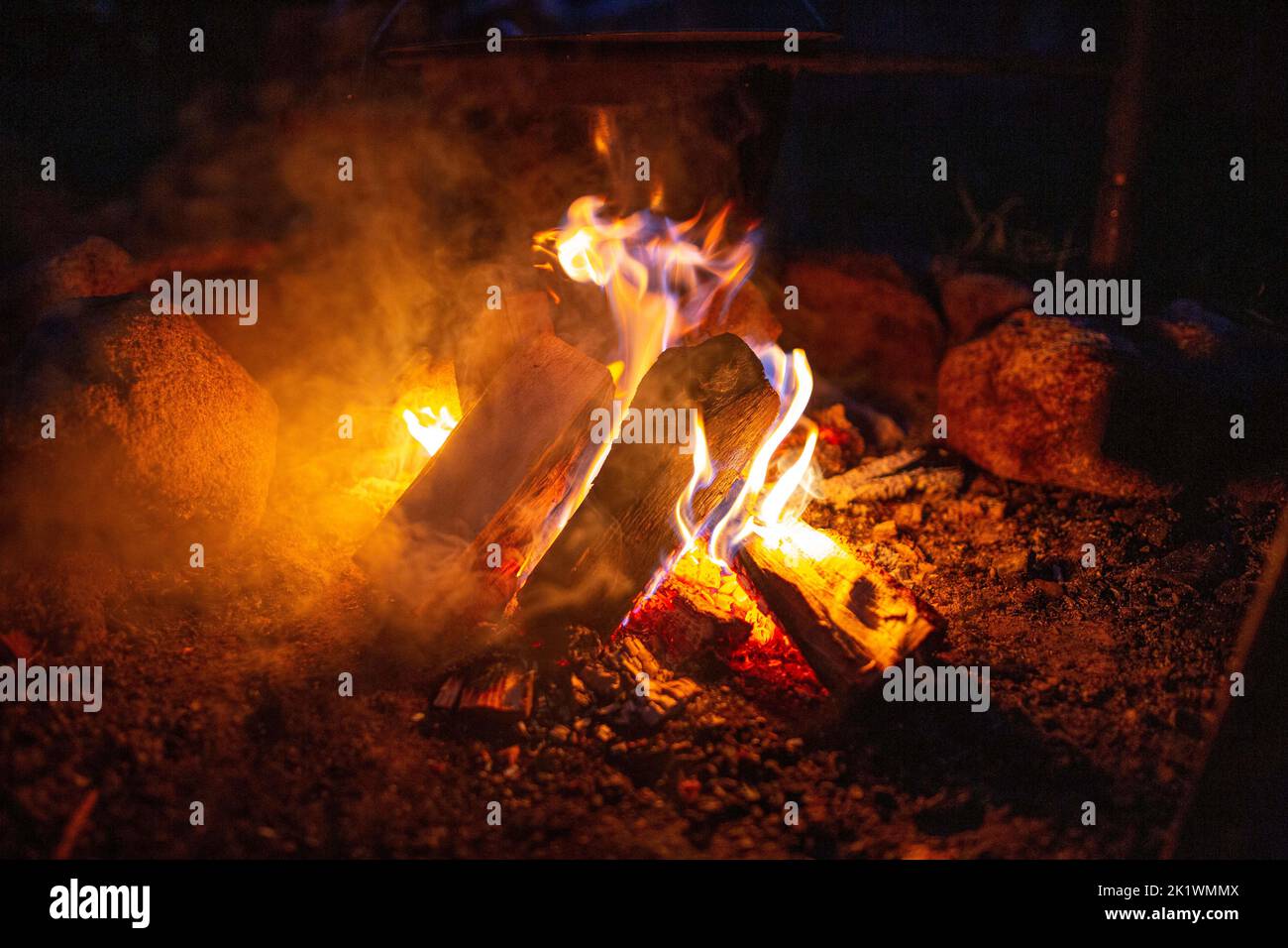A campfire burning at night in a fire pit Stock Photo Alamy
