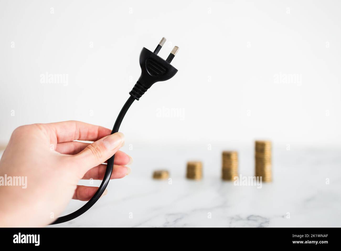 electricity costs going up conceptual image, plug with growing stacks