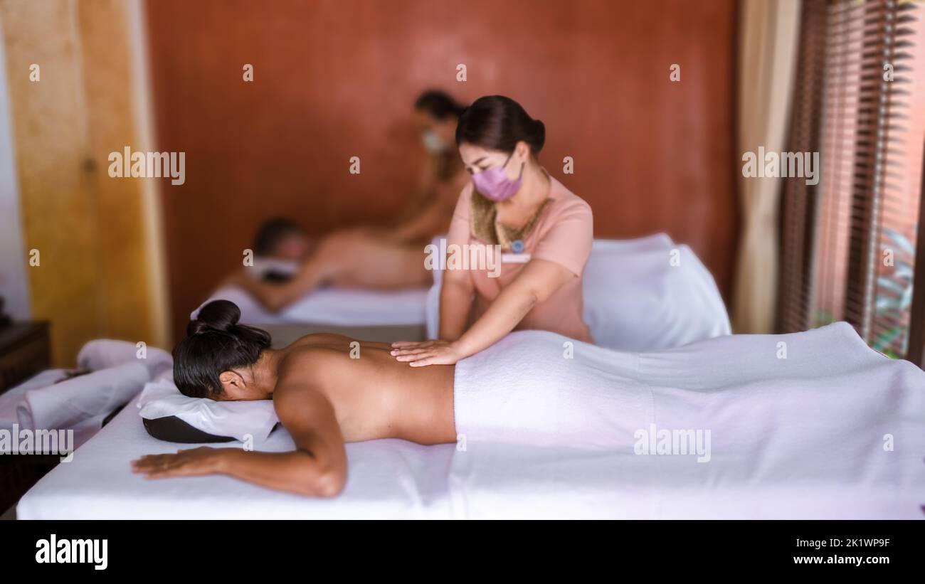 Couple men and women getting a Thai massage. European men and Thai women  getting a massage in a luxury hotel in Thailand Stock Photo - Alamy