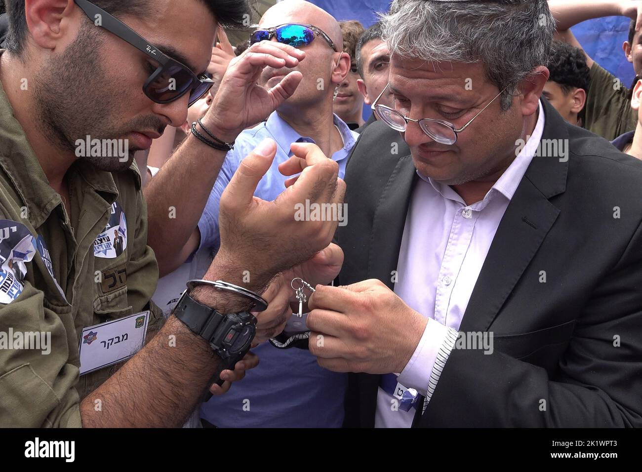 A right wing activist dressed in military uniform has his handcuffs unlocked by extreme Right-wing lawmaker Itamar Ben-Gvir, head of the Otzma Yehudit political party, as a symbol of easing the army's policy against Palestinians during Ben Gvir visit in Bleich school on September 20, 2022 in Ramat Gan, Israel. Bleich High School holds a mock parliamentary election and panel ahead of every election, inviting members of all parties to participate. The high school has earned a reputation for accurately predicting the results of previous Knesset elections. Stock Photo