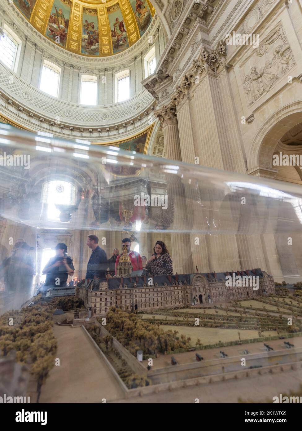 Tourists inside the Hotel Des Invalides in Paris, France, in front of a model of the historic building Stock Photo