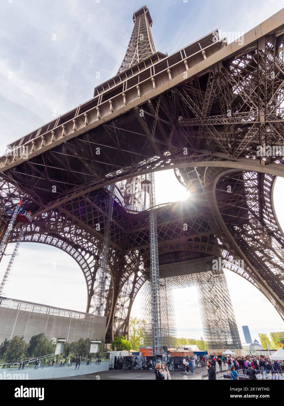 People are queueing below Paris Eiffel tower to get up to the observation platform Stock Photo