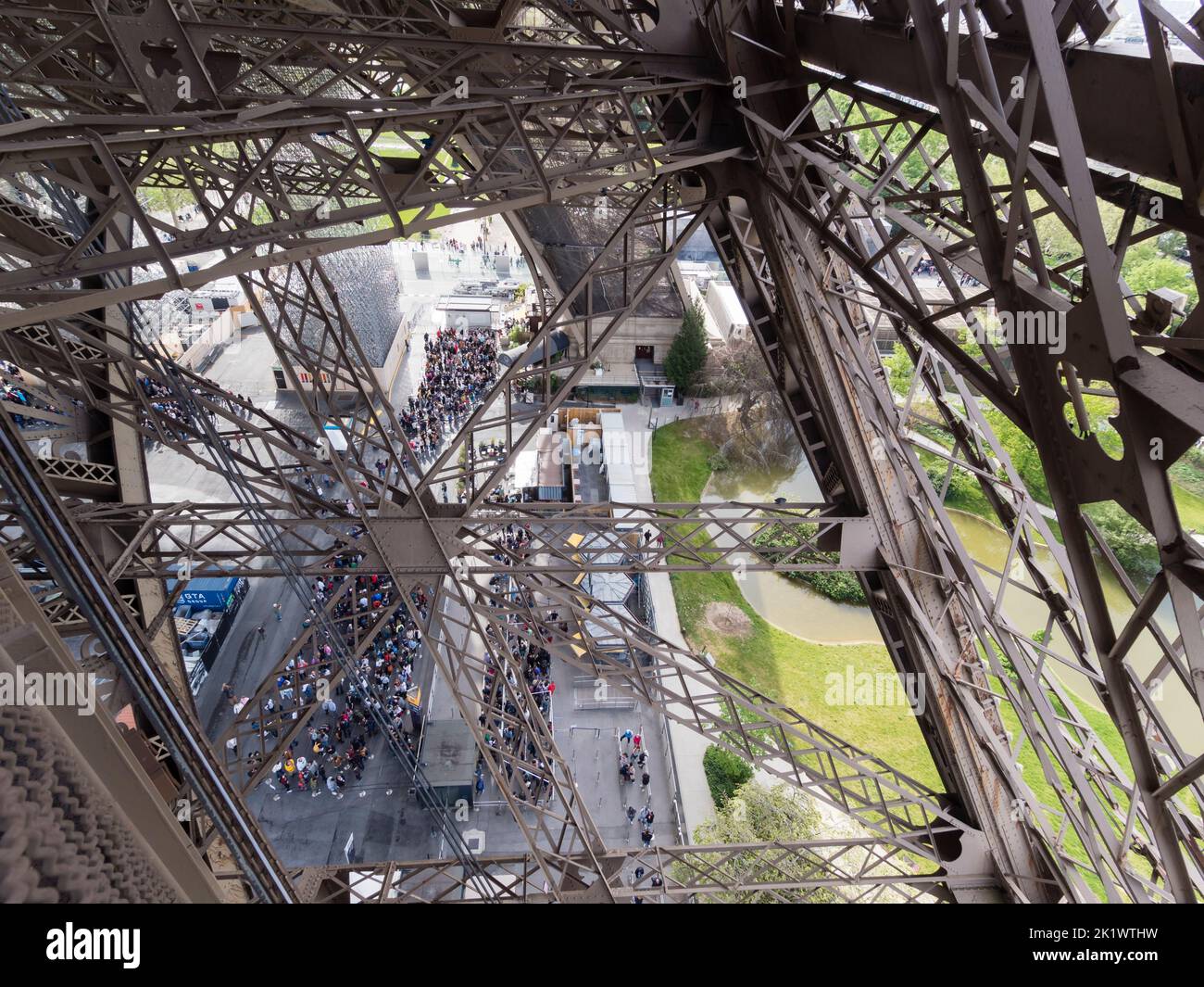 People are queueing below Paris Eiffel tower in order to get up to the observation platform Stock Photo