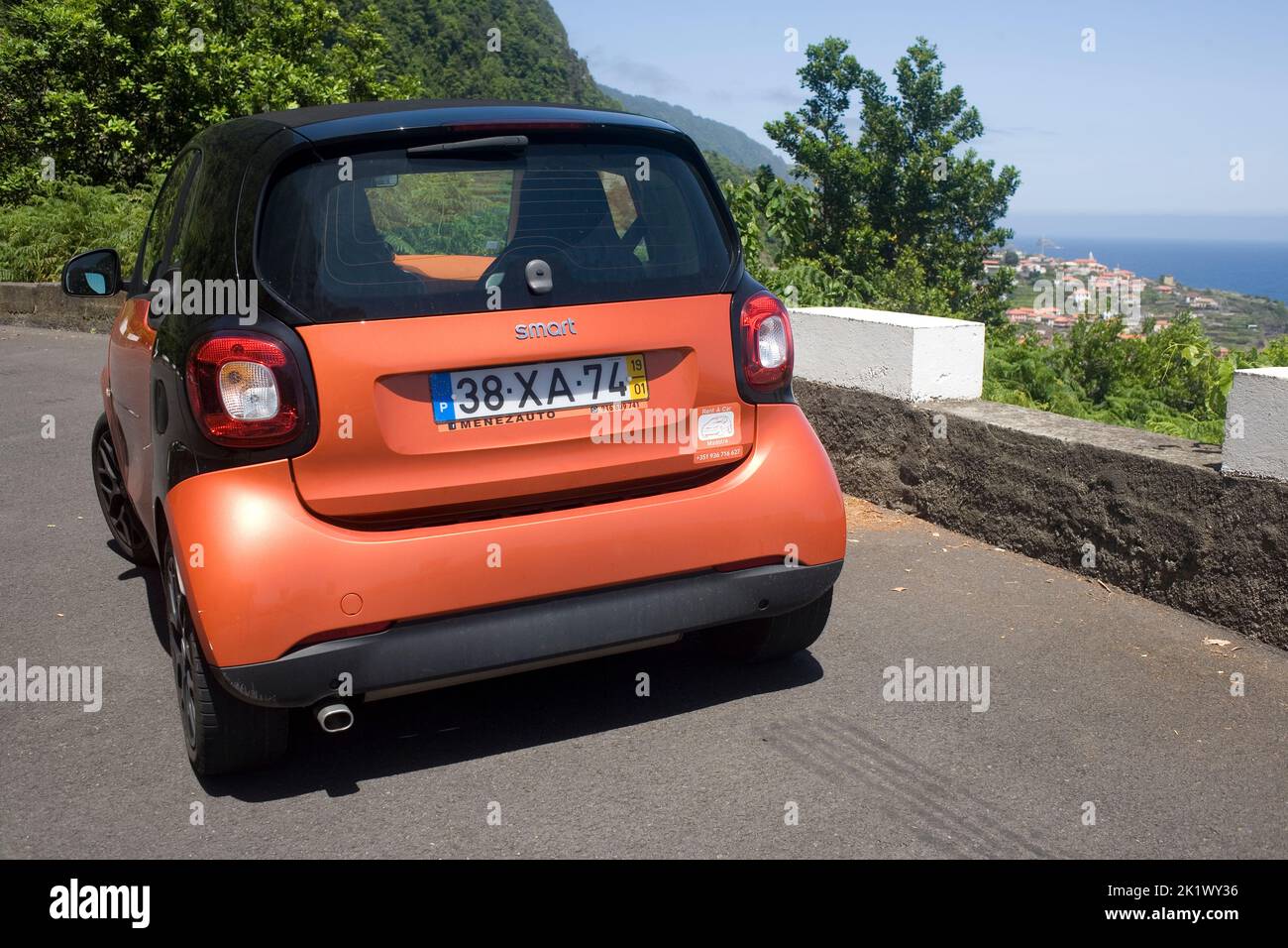 Orange Smart car parked at Veu de Noiva viewpoint near Seixal on North coast of Madeira Stock Photo