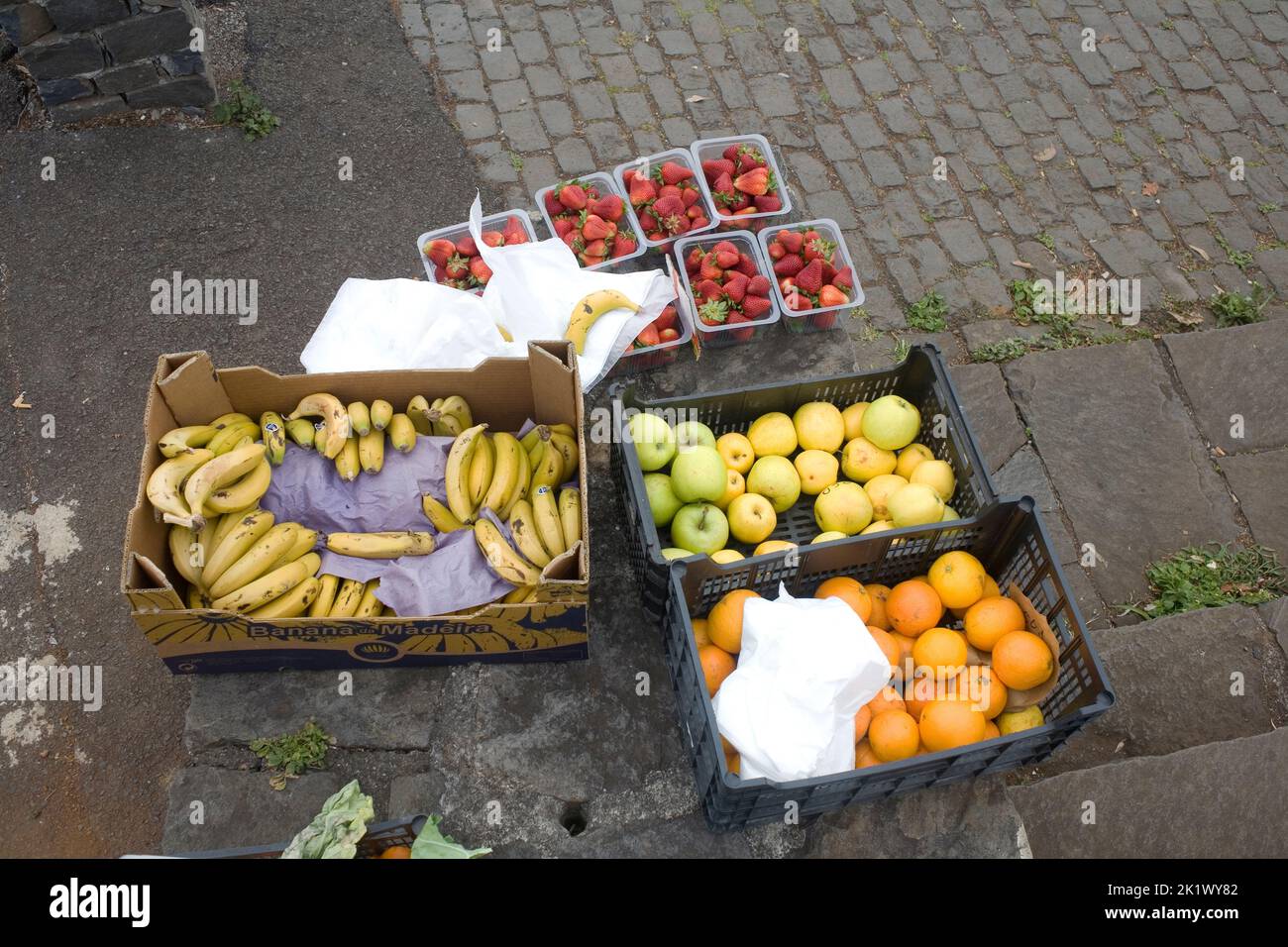 selection of fruit: bananas, oranges, apples and strawberries, for sale at roadside near Boaventura in Northern Madeira Stock Photo