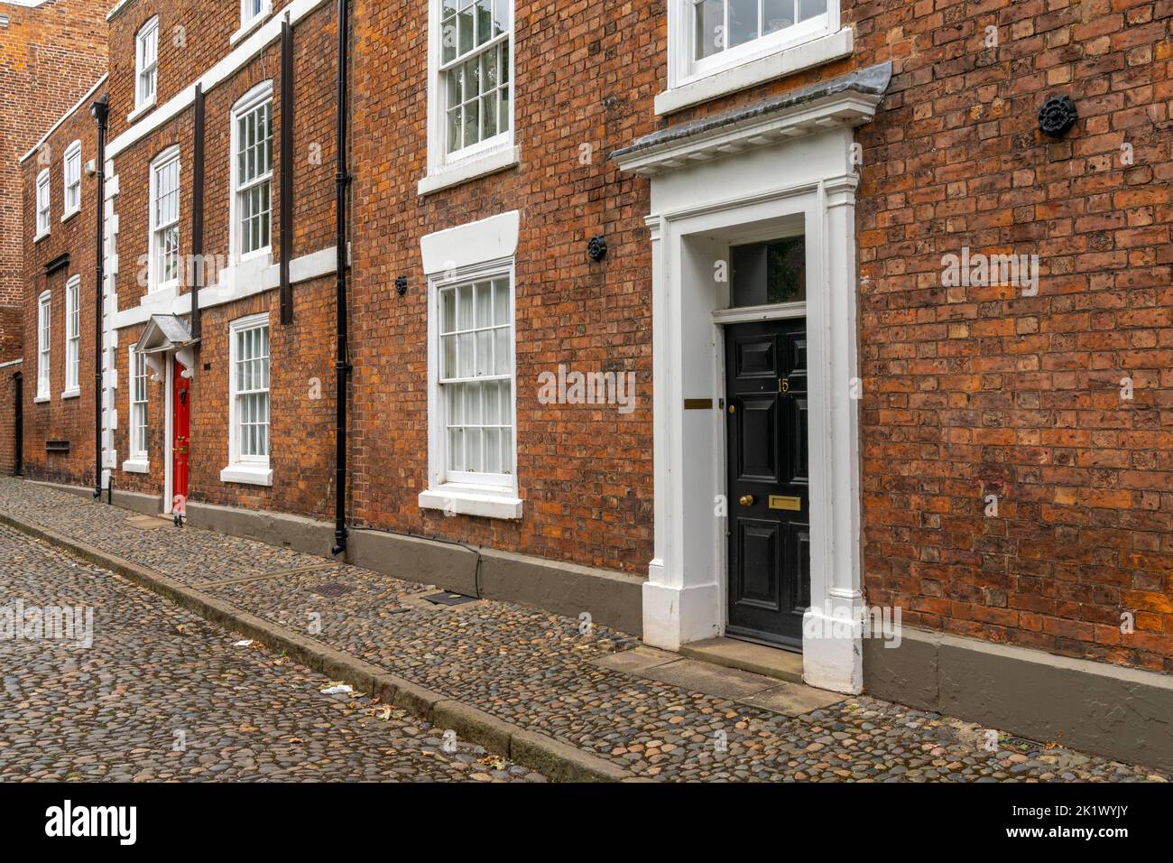 Chester, United Kingdom - 26 August, 2022: red brick buildings with colorful doors in typical English fashion in the historic city center of Chester Stock Photo
