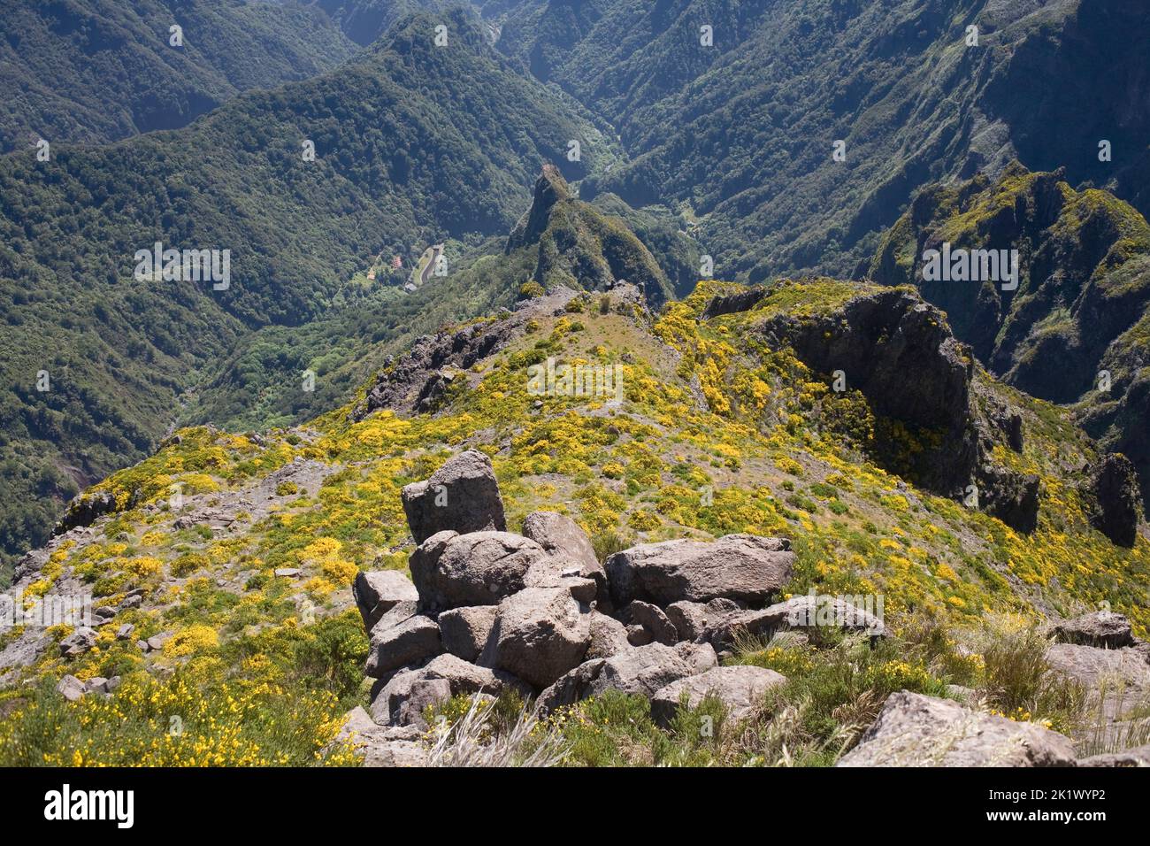 View from the summit of Pico do Areiero in central Madeira with foreground rocks and distant forest Stock Photo