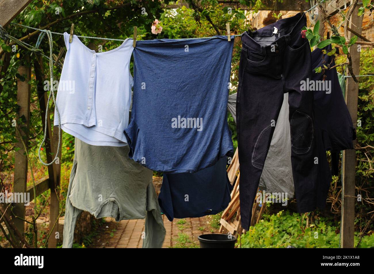 Washed clothes drying outside on washing line Stock Photo