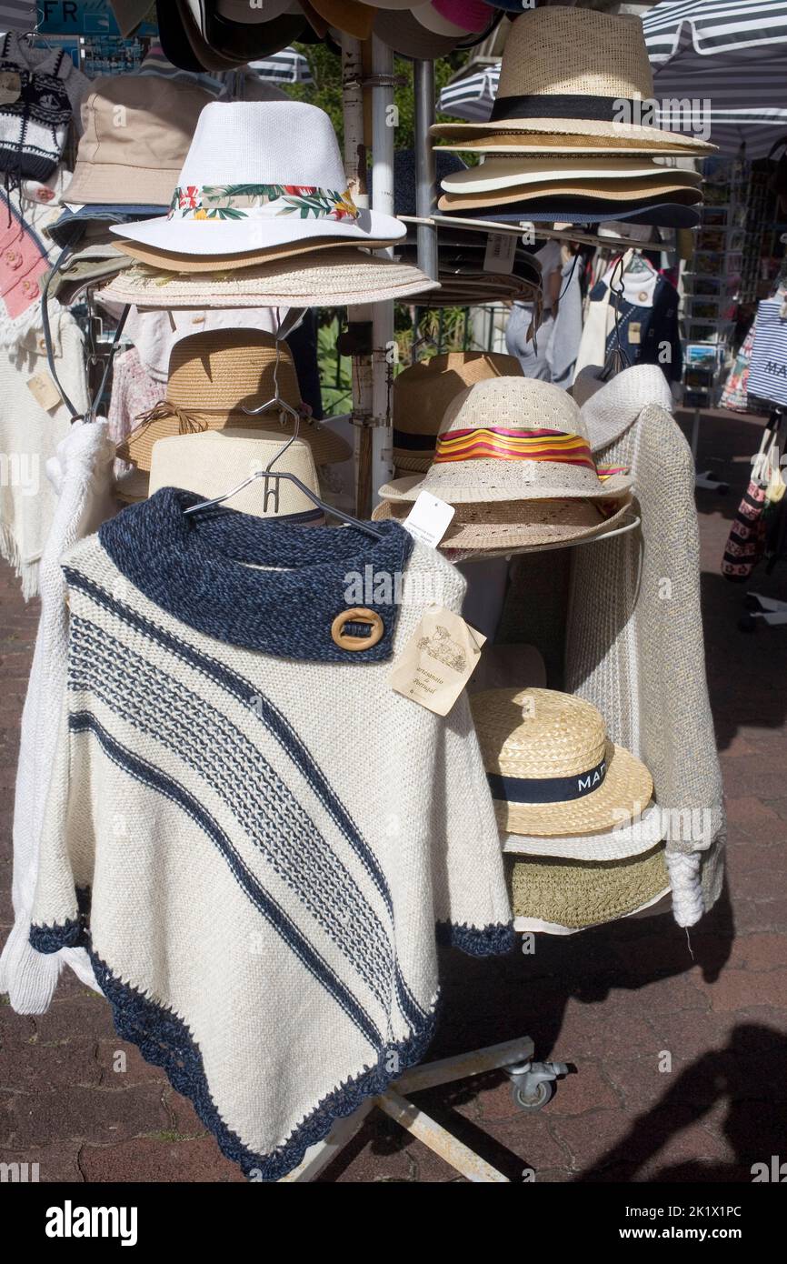 piles of hats and hanging jumpers for sale in Funchal Madeira Stock Photo