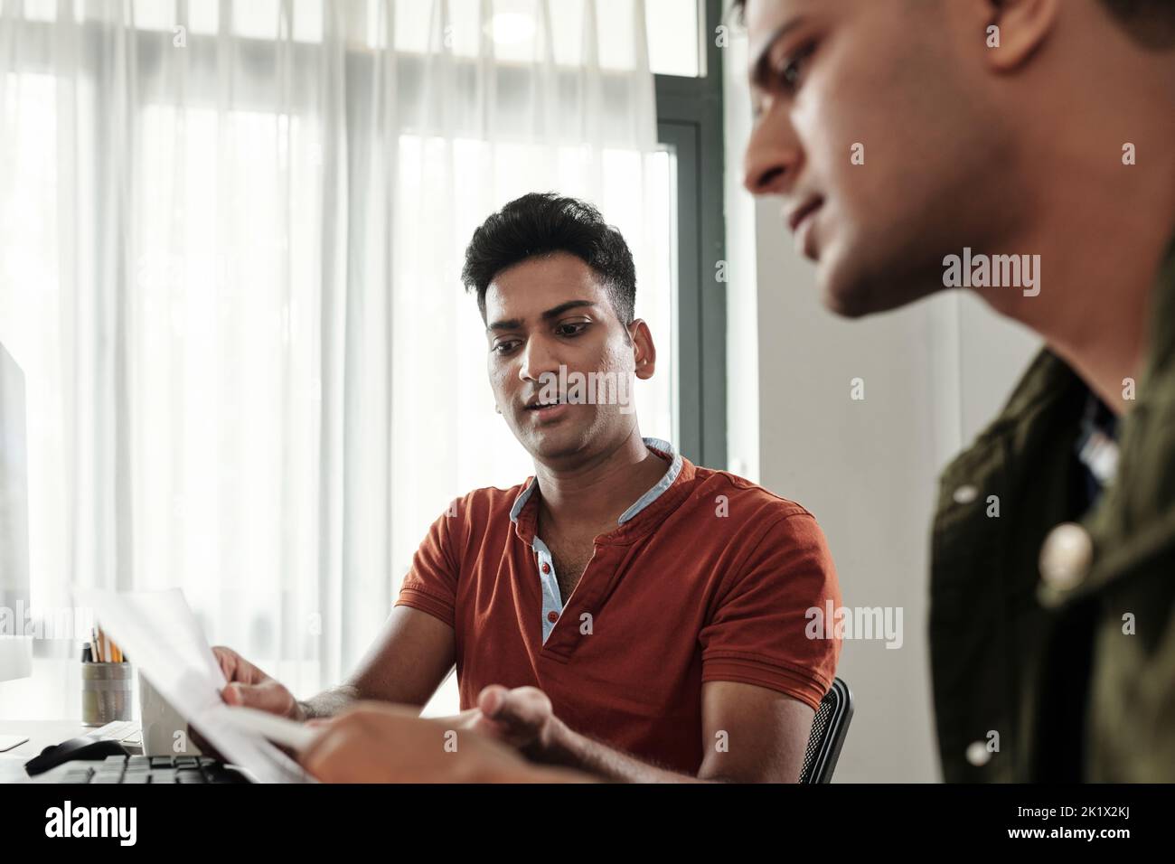 UI designer showing website wireframe to software developer Stock Photo