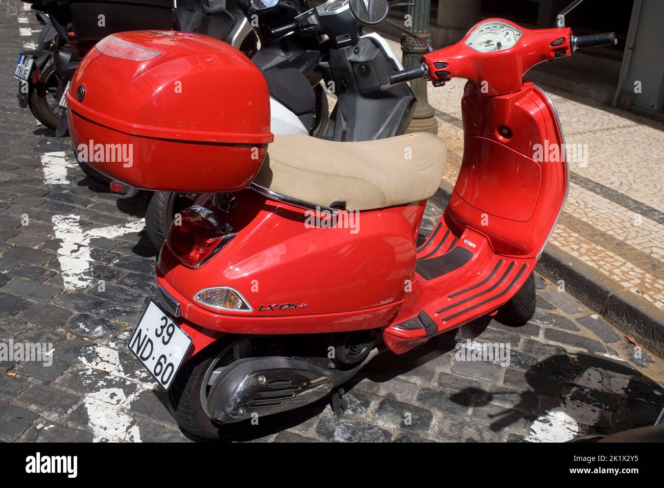 red Vespa X125 scooter parked in central Funchal Madeira Stock Photo