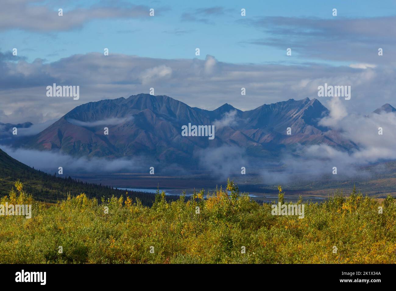 Picturesque Mountains of Alaska in summer. Snow covered massifs, glaciers and rocky peaks. Beautiful natural background. Stock Photo