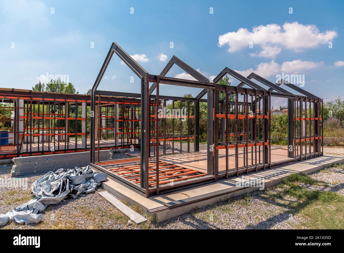 Metal frame of newly built building. Construction of a new tiny house Stock Photo