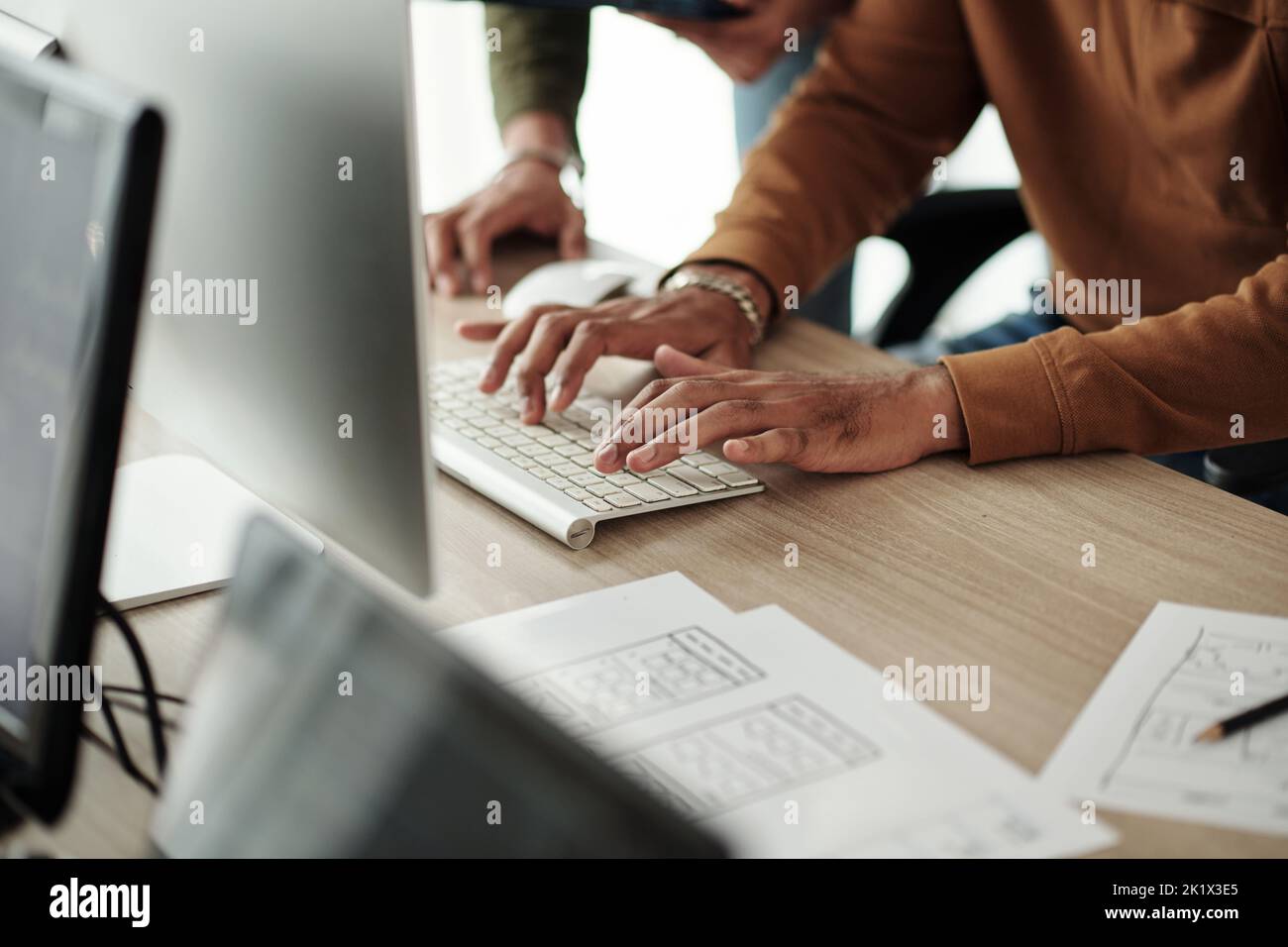Closeup image of junior software developer programming under control team leader Stock Photo