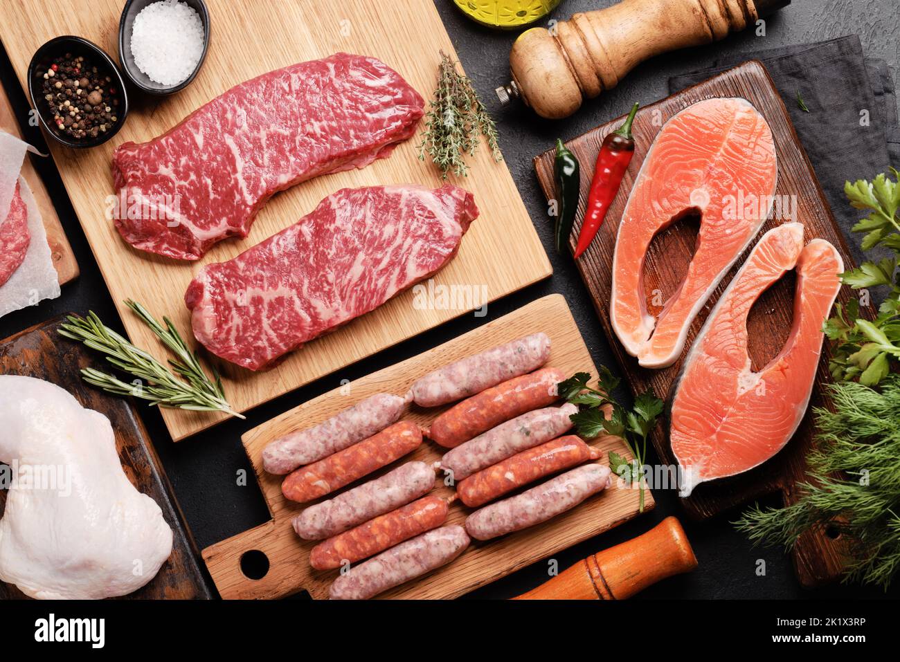 Various raw meat and fish. Steaks, sausages, salmon, chicken and spices. Flat lay Stock Photo