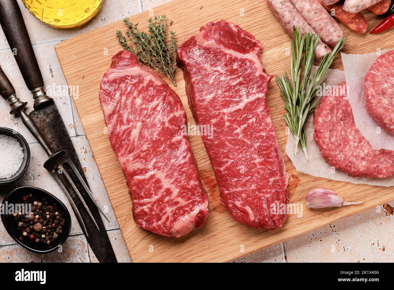 Various raw meat. Steaks, sausages, burgers and spices. Flat lay Stock Photo