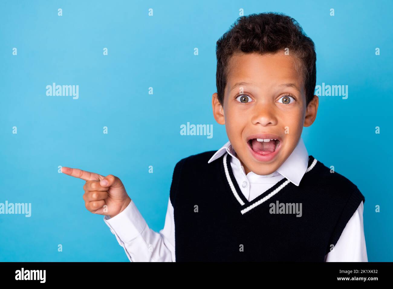 Photo of impressed funny small boy wear black waistcoat pointing finger