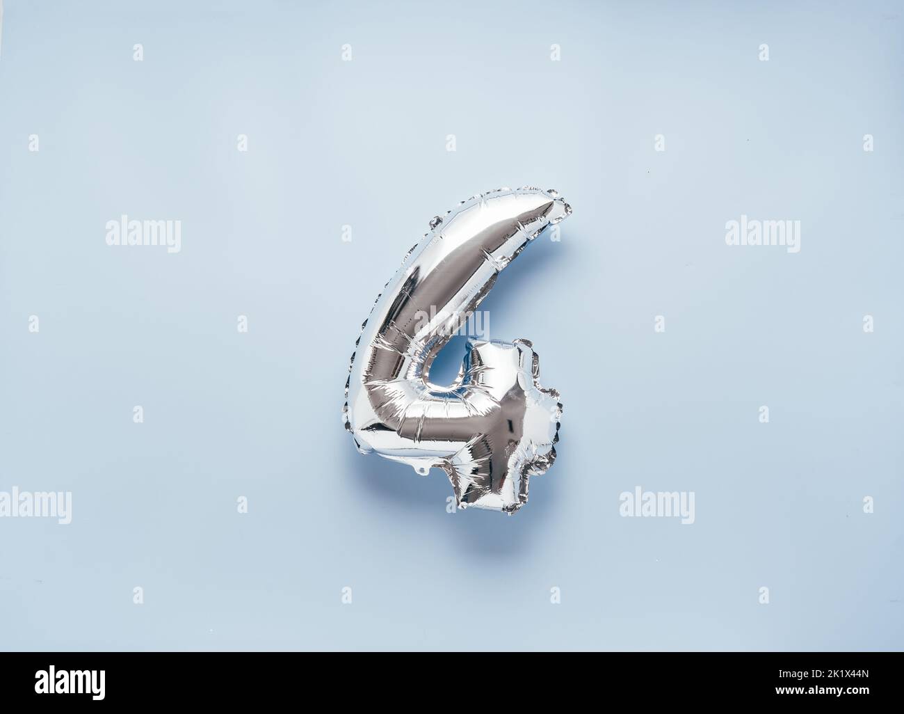 Silber balloon number 4 on light blue background for your New Year of birthday desing Stock Photo