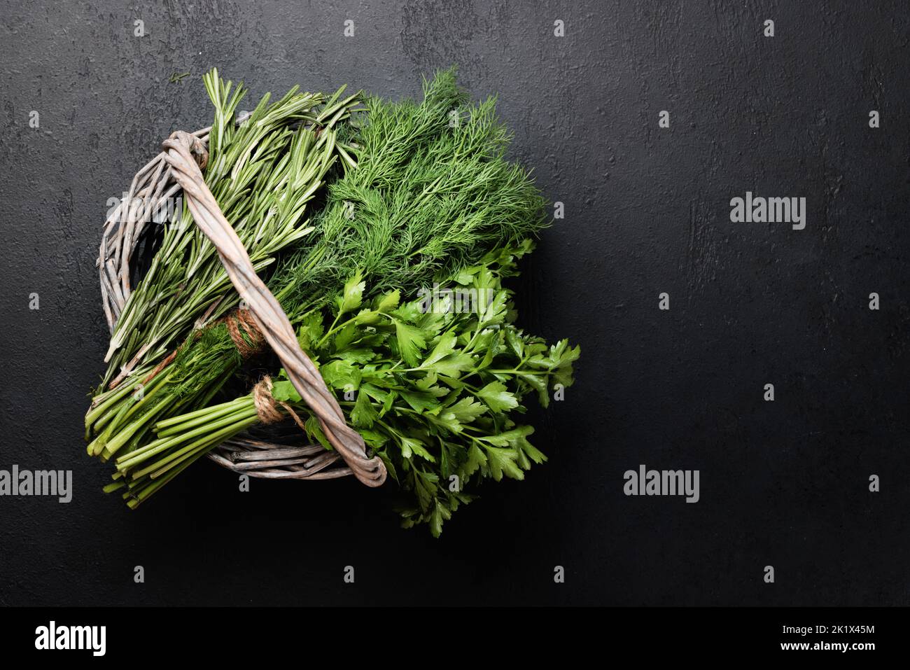 Various garden herbs in basket. Dill, parsley, rosemary. Flat lay with copy space Stock Photo