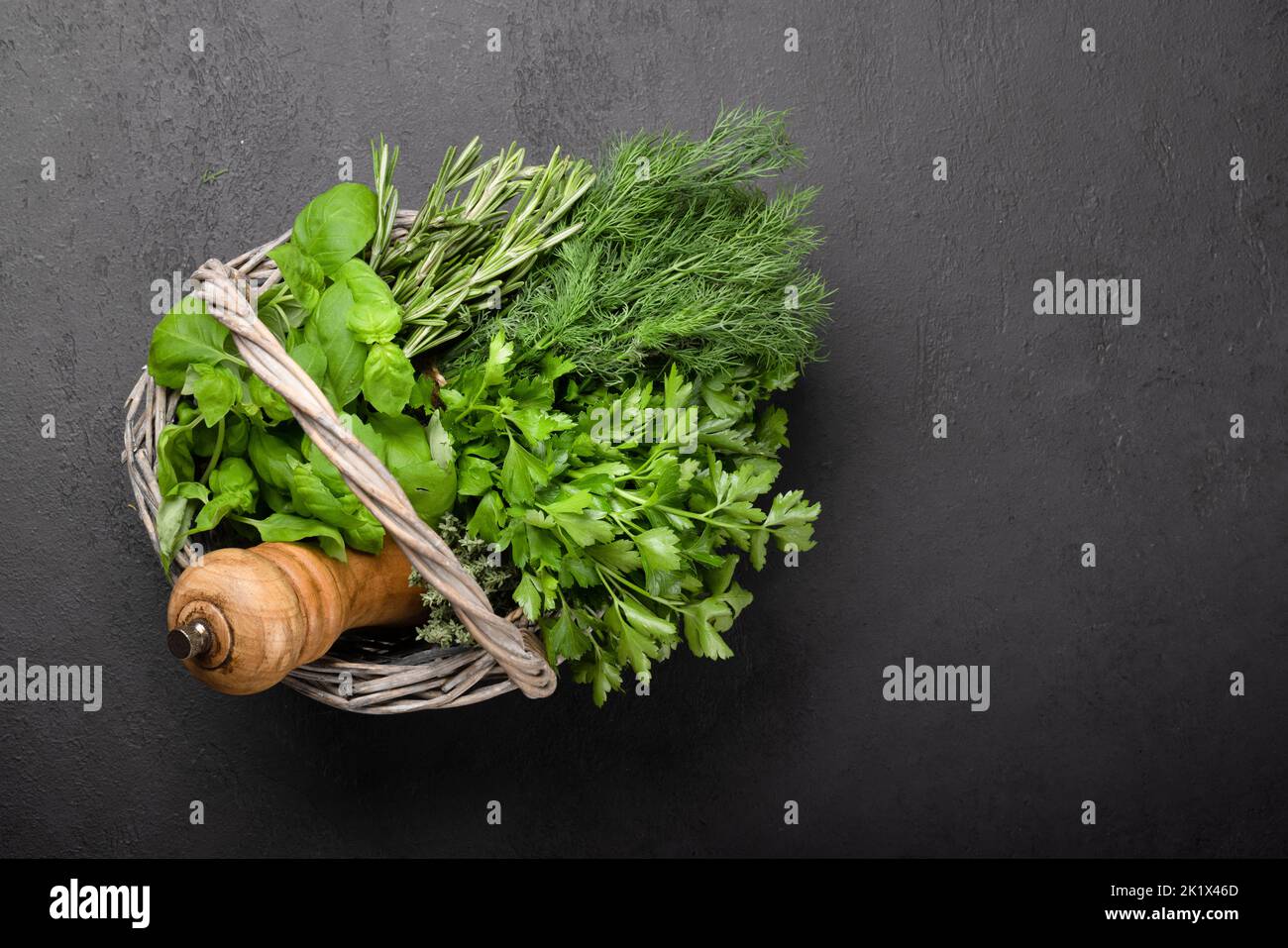 Various garden herbs basket. Basil, dill, parsley, rosemary. Flat lay with copy space Stock Photo