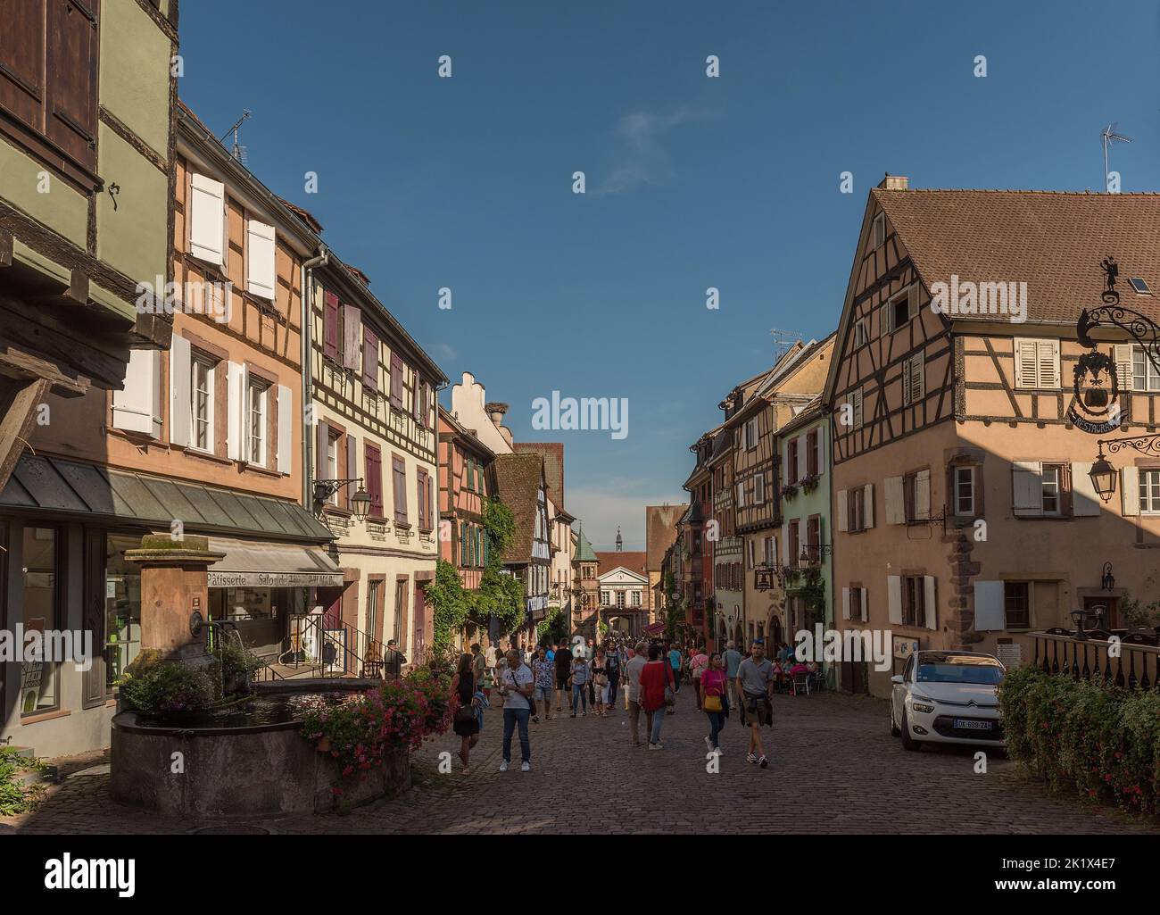 People on street in medieval village of Riquewihr, Alsace, France Stock Photo