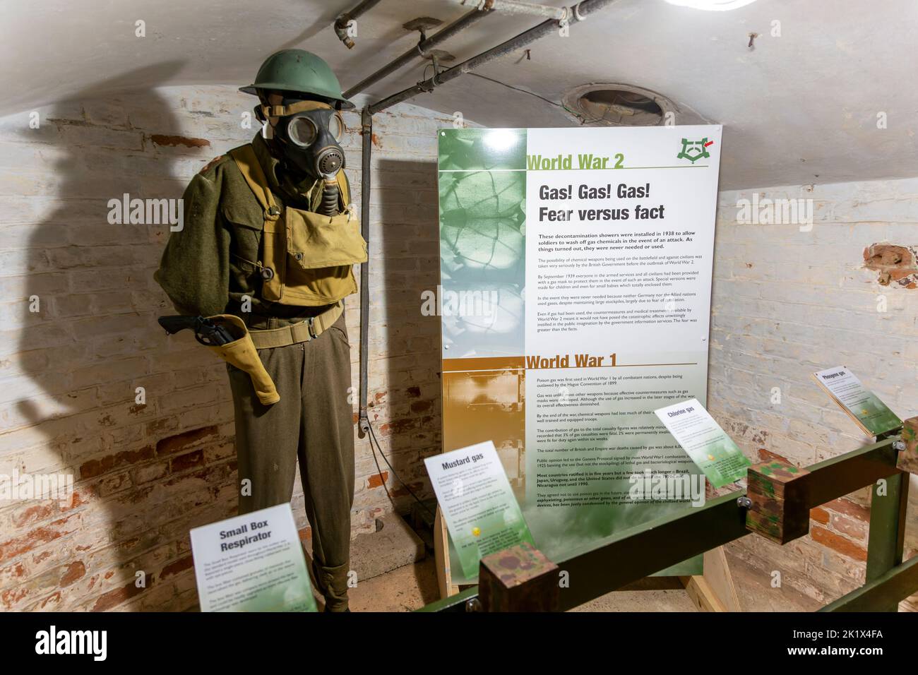 Display information 1940s mannequin in uniform wearing gas mask, Landguard Fort, Felixstowe, Suffolk, England, UK Stock Photo