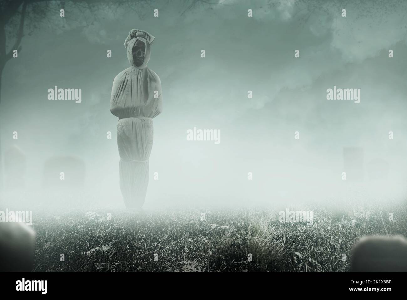 Pocong is covered with a white linen shroud standing in the cemetery ...