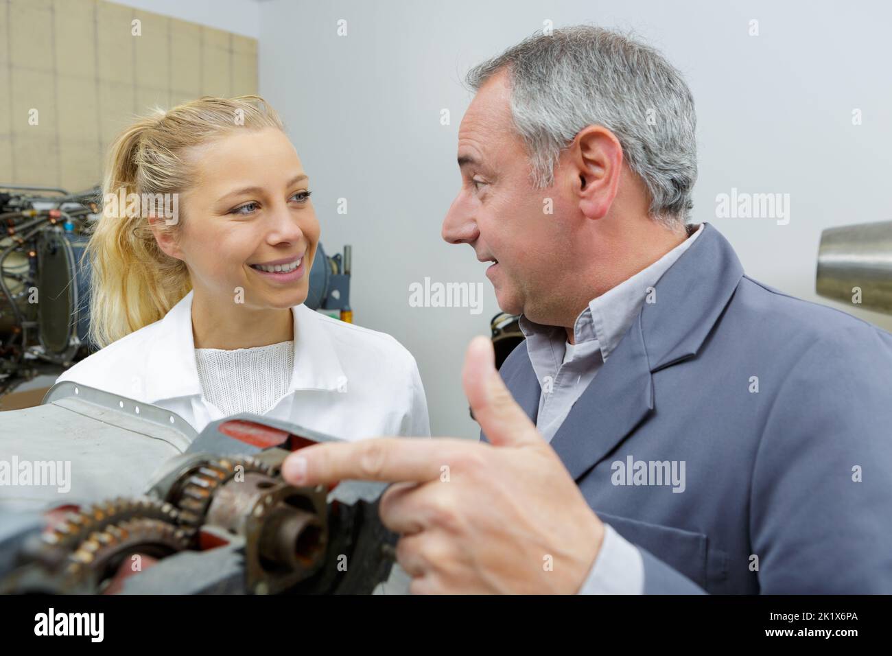 aero engineer and apprentice working in hangar Stock Photo