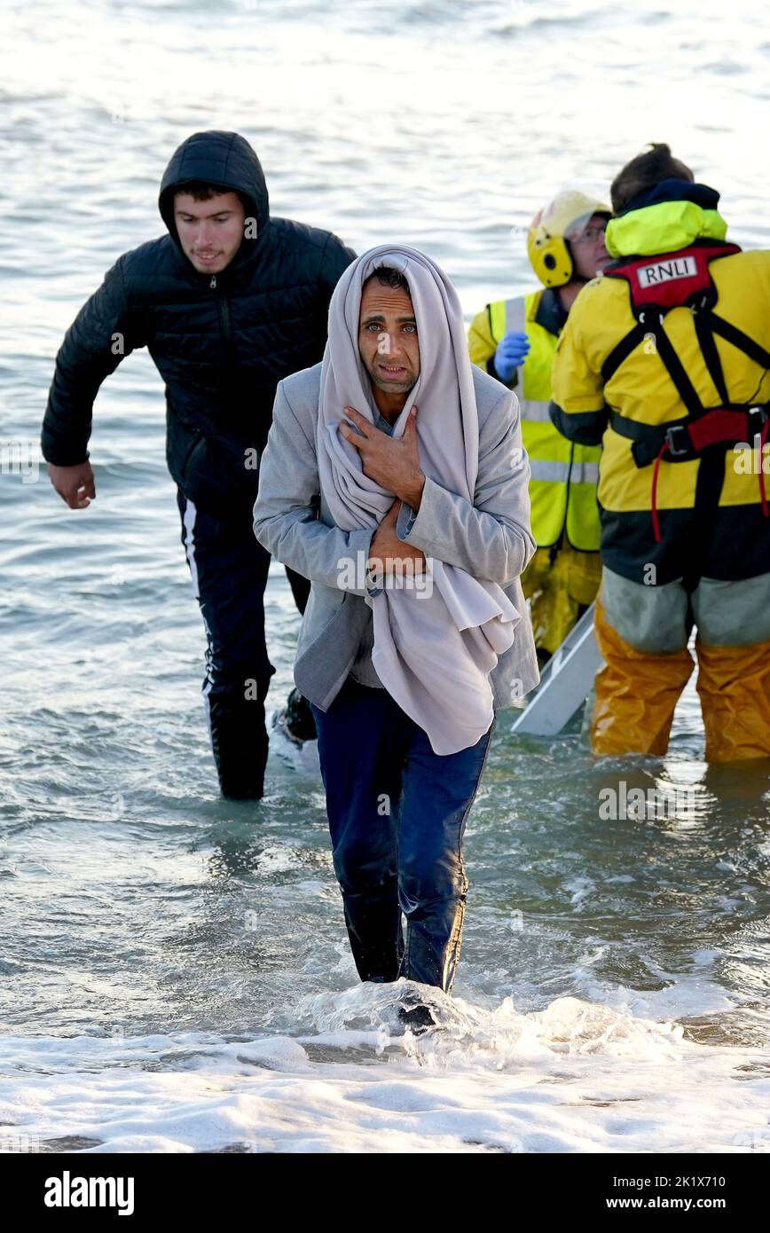 A group of people thought to be migrants walk to shore in Dungeness, Kent, after being rescued in the Channel by the RNLI following following a small boat incident. Picture date: Wednesday September 21, 2022. Stock Photo