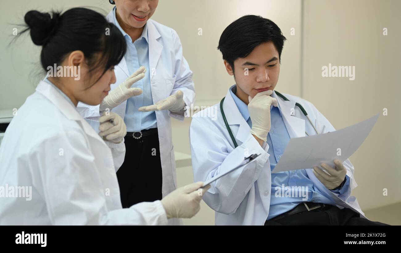 Professional scientists wearing white coats conducting experiment in