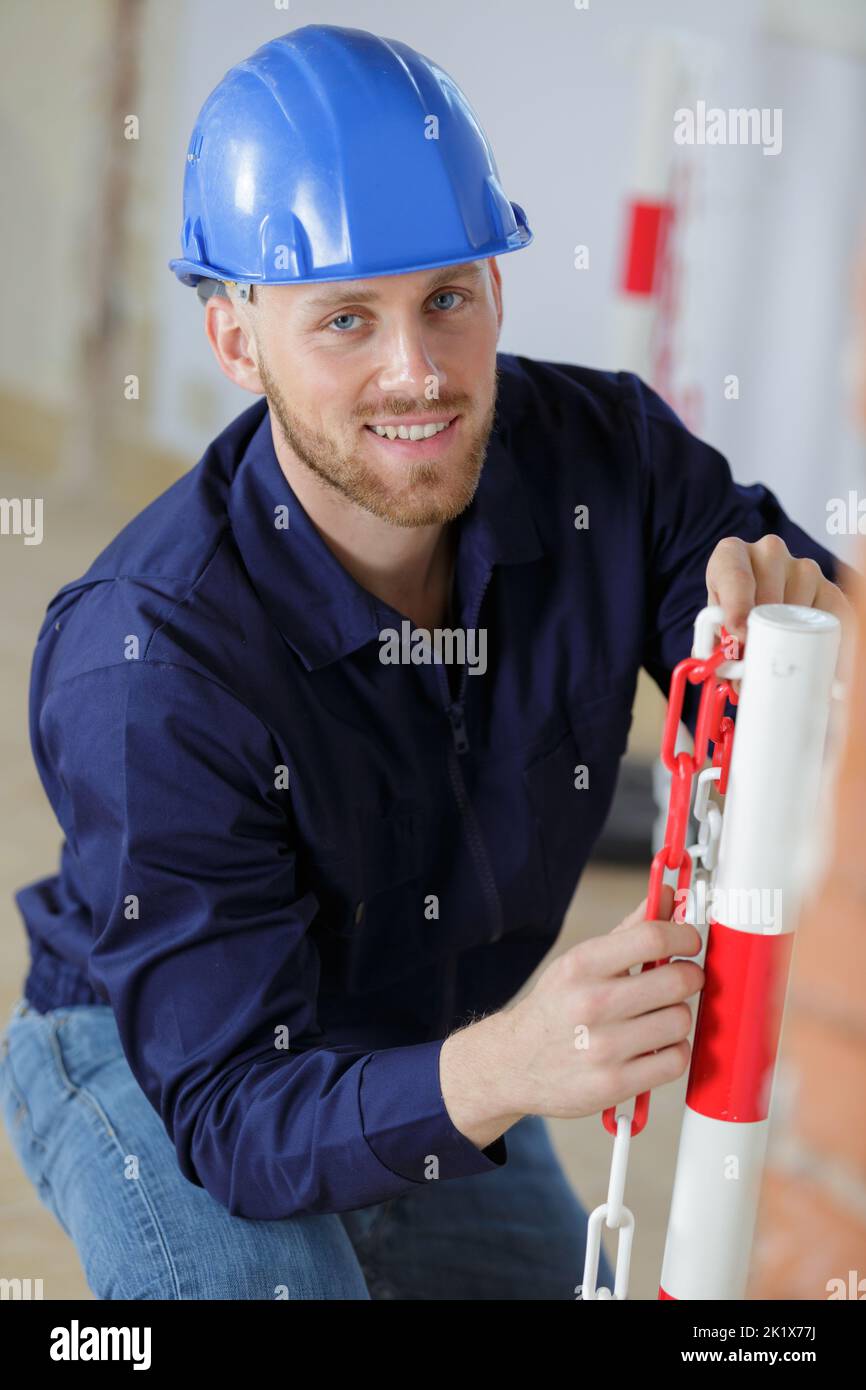 builder setting up site exclusion chain Stock Photo - Alamy