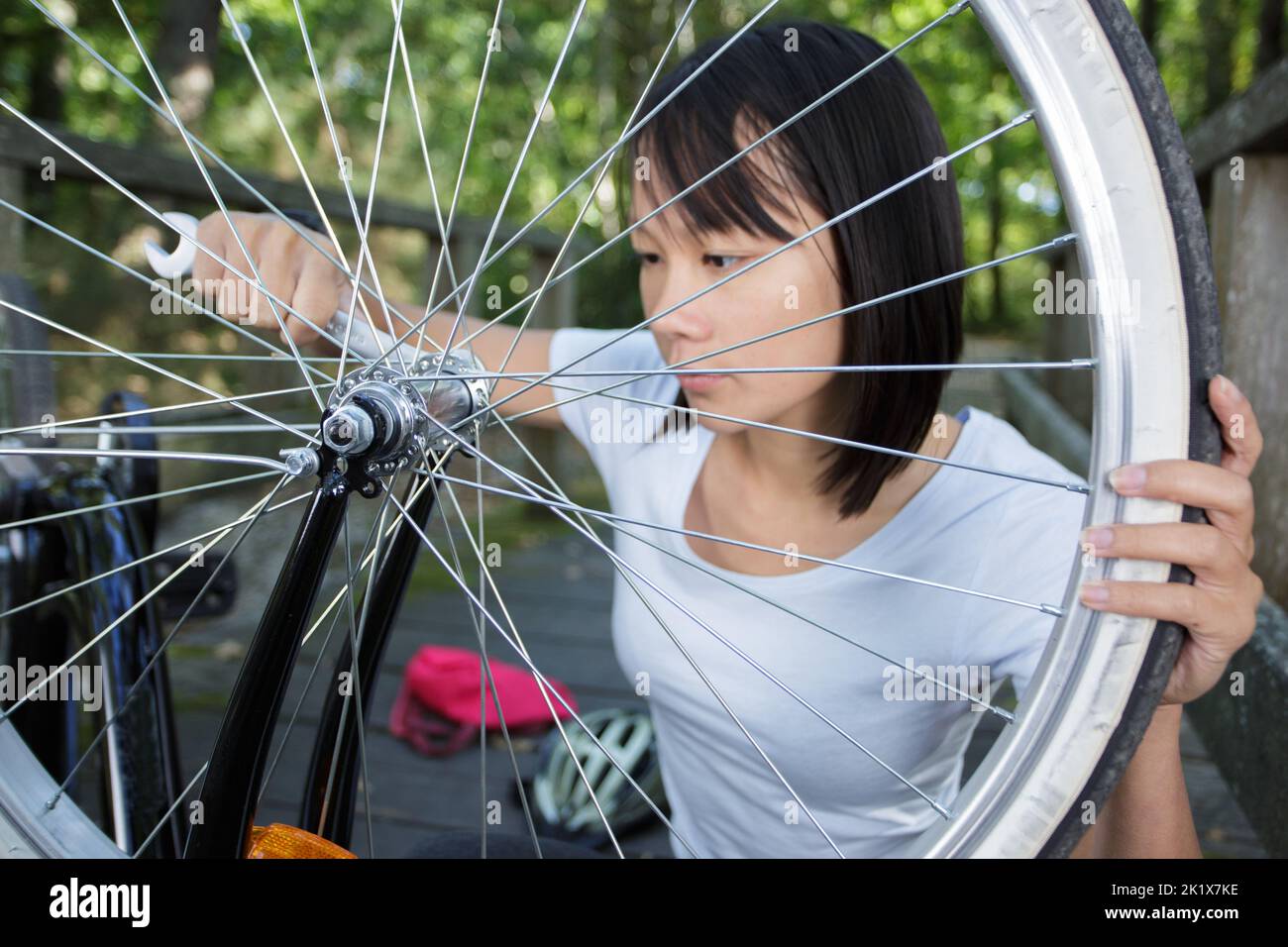 female cyclist fixing the bike Stock Photo Alamy